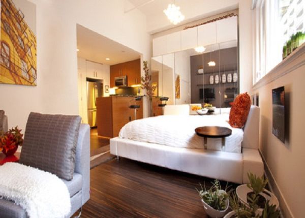 small-studio-apartment-bedroom-decor-with-mirrored-storage-unit